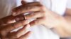 Someone removing their wedding ring during divorce proceedings