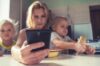 A mum reading her something on her phone regarding a section 7 report requirement from CAFCASS.